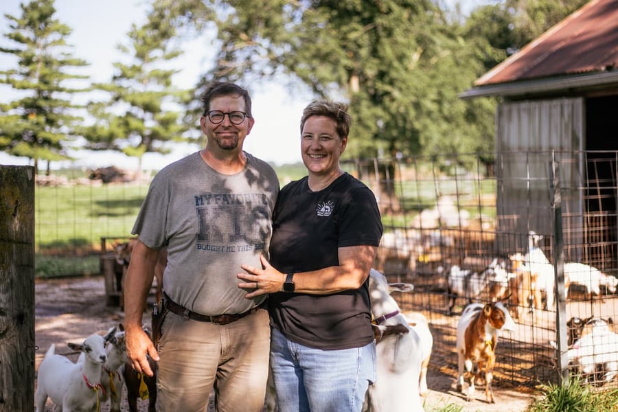Tracy and Ed of Goat Shine standing with their Nigerian dwarf goats
