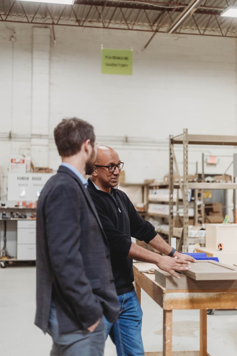 Aman Bajwa of the Kambium Group with Kevin Hegland of Security Bank & Trust Co. on the shop floor