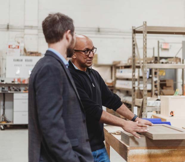 Aman Bajwa of Kambium Group on the Perfection Custom Closets production floor with his Security Bank lender