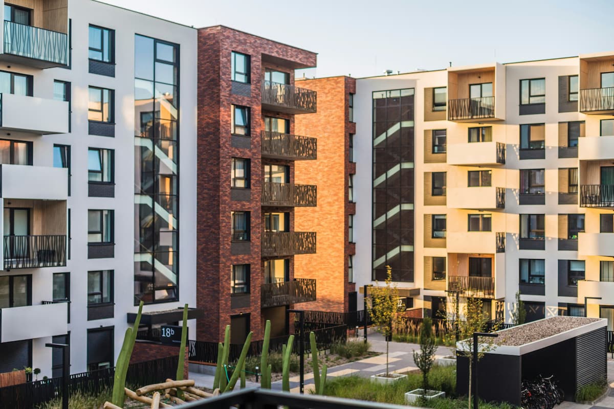 A multifamily apartment community with balconies and a landscaped courtyard