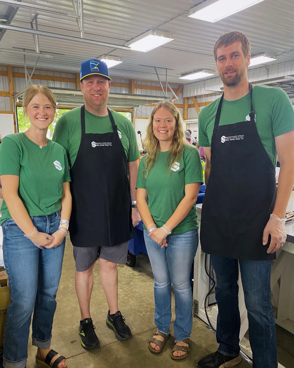 Four Security Bank & Trust Co. employees in aprons serving at the Glencoe Days block party
