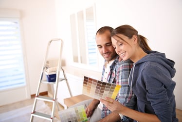 A Minnesota homeowner couple selecting paint colors for their home improvement project, showcasing thoughtful renovation planning and creative updates, supported by smart home improvement financing.