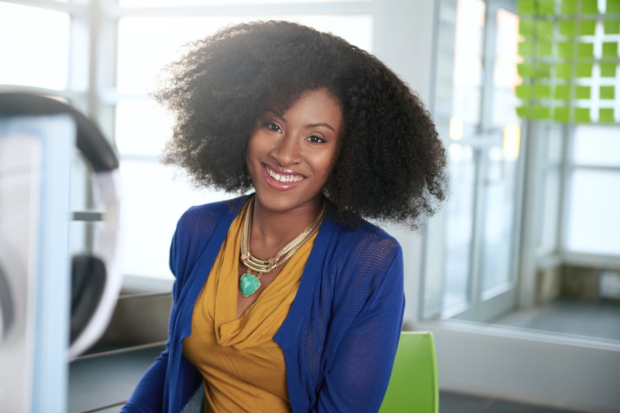 Business owner managing accounts from a computer in a bright office