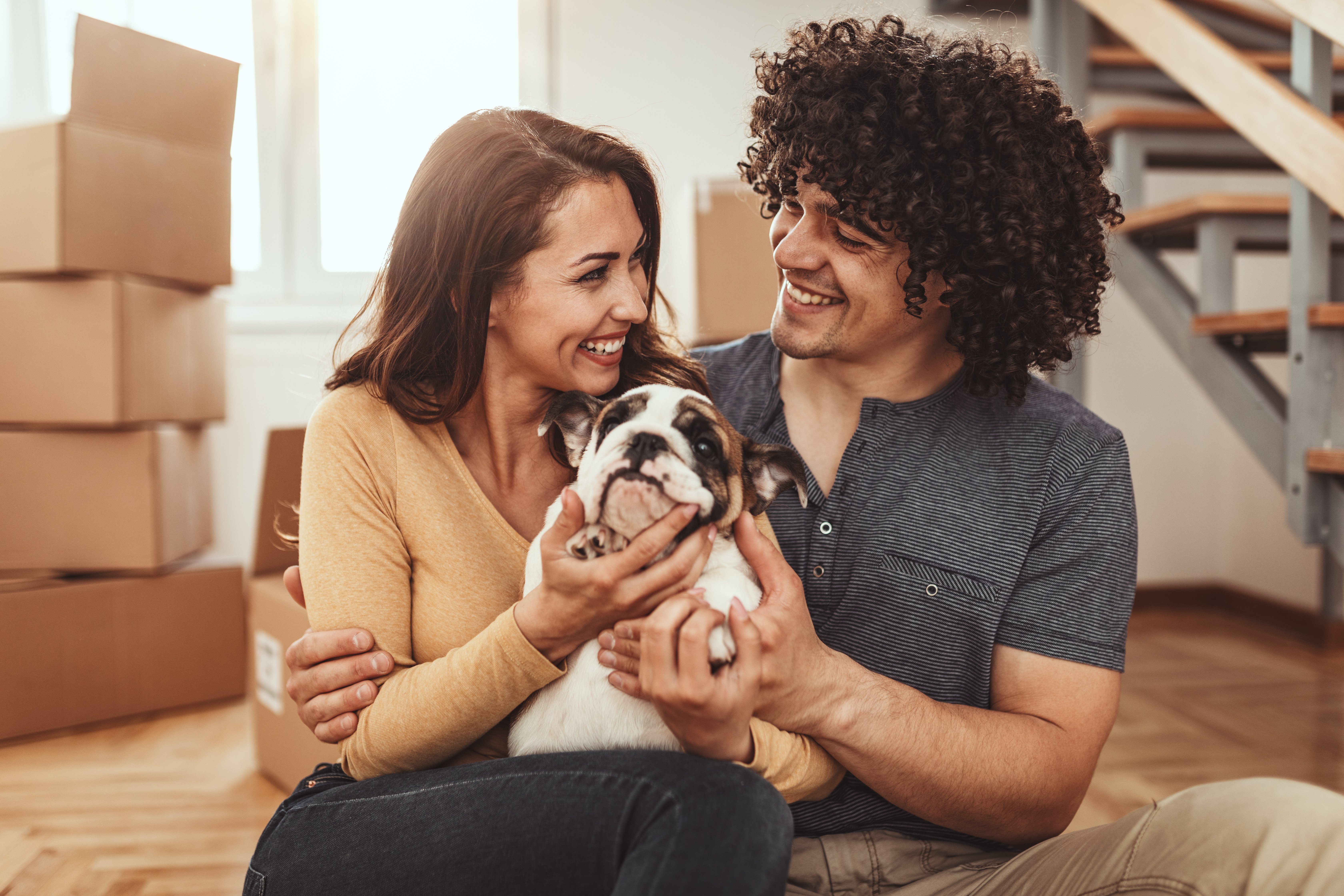 couple and their dog moving into a home