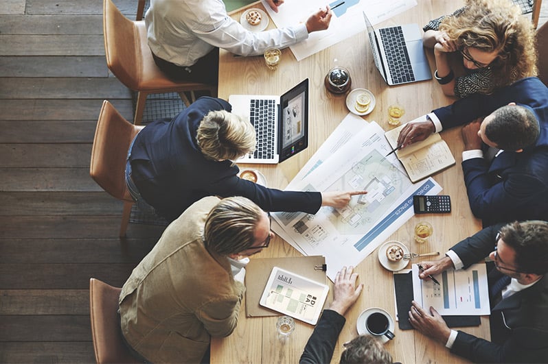 Business people discussing and planning over coffee