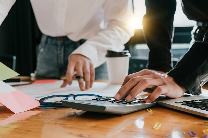 Men using a calculator