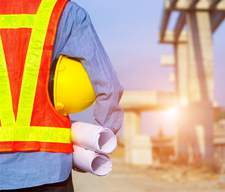 Construction worker with helmet and blueprints