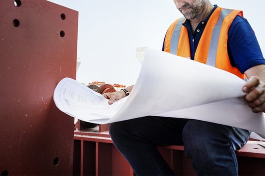 construction worker reading blueprint