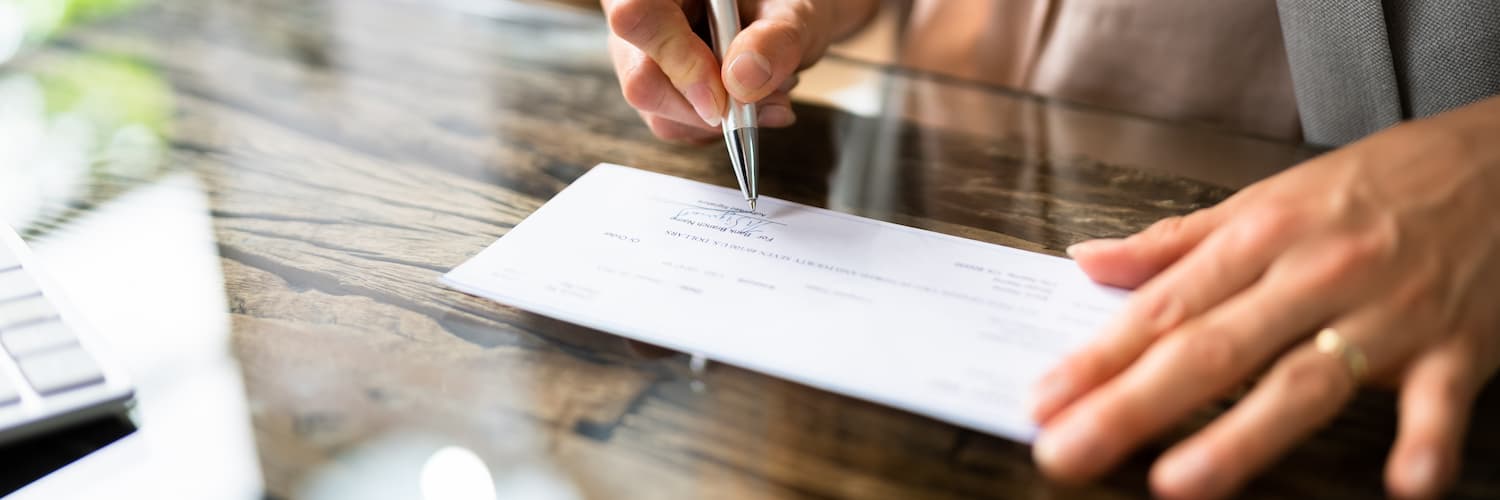 person signing a business check