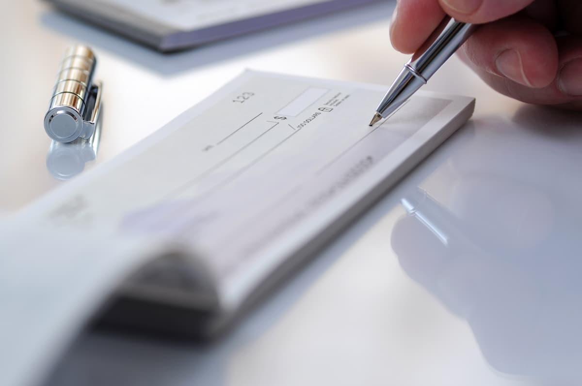 person signing a check