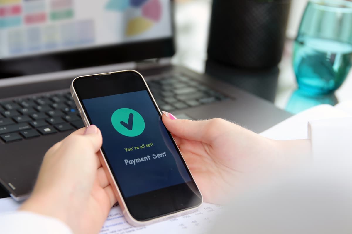 person sending a payment from their mobile phone