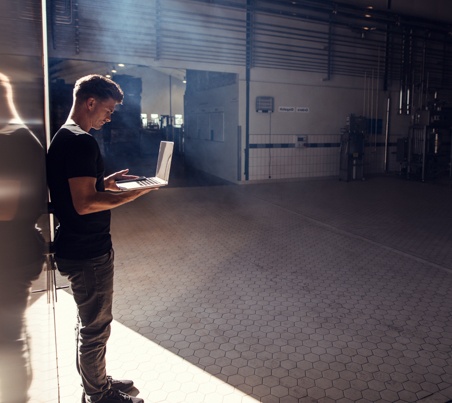 man on computer in empty room