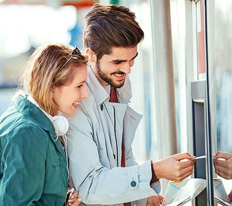 couple using atm machine