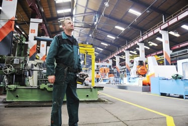 small business owner looking at his equipment