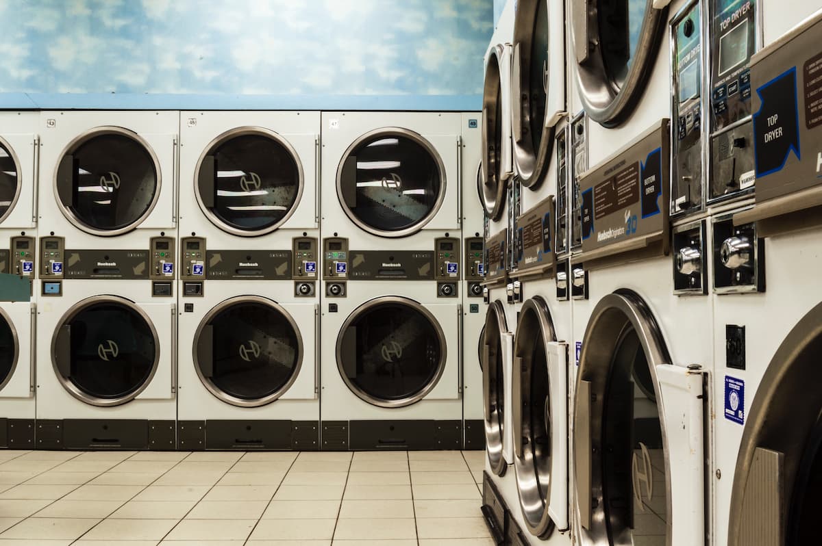 Row of commercial washing machines inside a laundromat