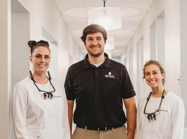 Dr. Jalissa Kruckman and Dr. Taylor Sawyer of Kruckman Family Dentistry with Brian Nosbush of Security Bank & Trust Co.