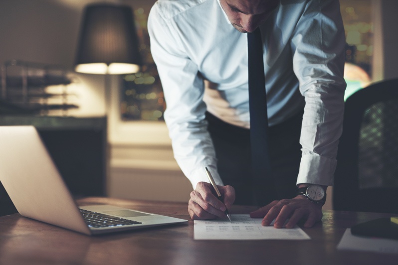 A Minnesota professional reviewing practice documents at a desk